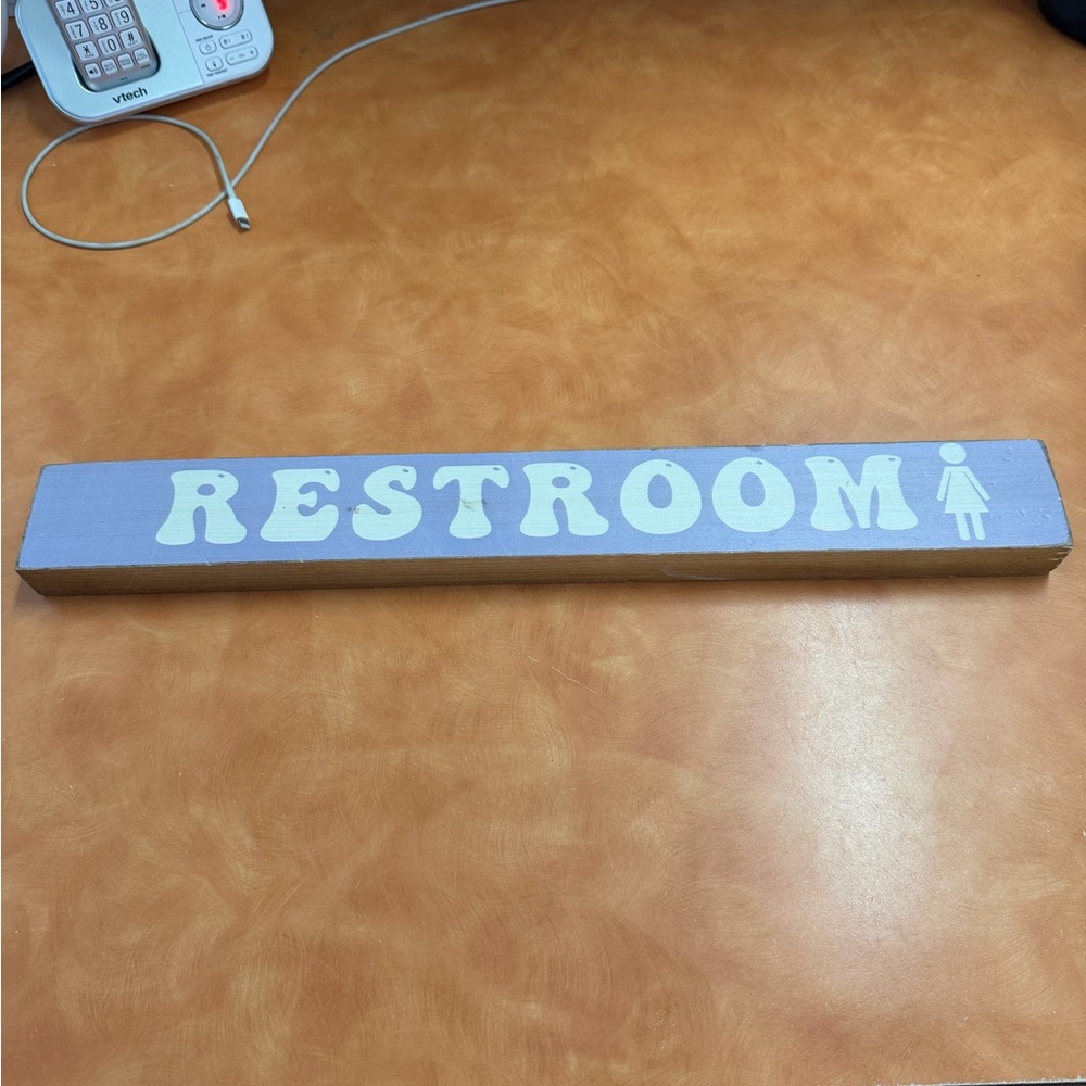 Purple Woman’s Restroom Sign